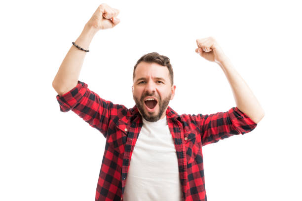 Man Celebrating Success On White Exhilarated man with mouth open and arms raised screaming on white background exhilaration stock pictures, royalty-free photos & images