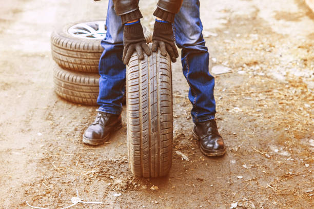 man changing wheel on a car stock photo