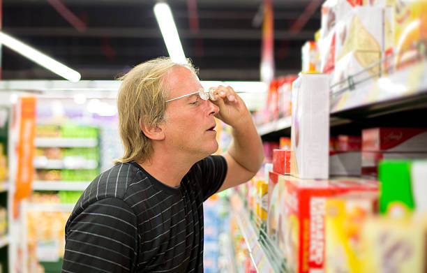 Man chooses products at the supermarket stock photo
