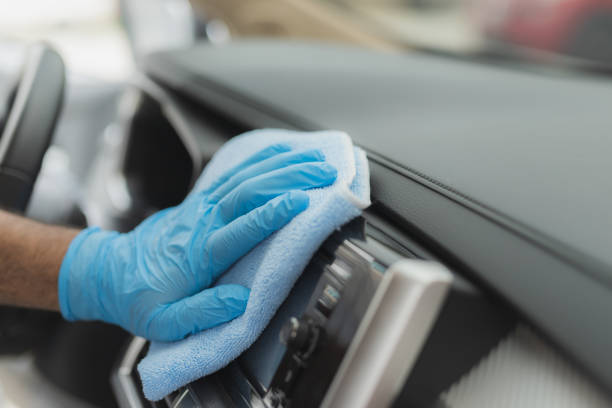 Man cleaning car with microfiber cloth stock photo