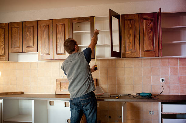 Man constructing cabinet units in new kitchen stock photo