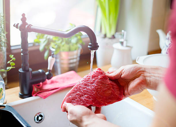 Man cooking Ungrcognizable man in the kitchen preparing beef steak cut of meat stock pictures, royalty-free photos & images