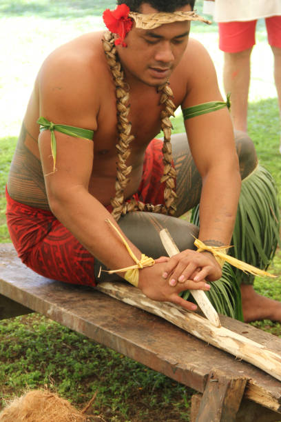 Man demonstrate lighting fire in Culltural Village. A samoan demonstrate how to light up a fire by using tradition method and coconut fibre. apia samoa stock pictures, royalty-free photos & images