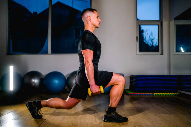 Man doing lunge with dumbbells