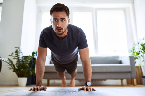 Man doing pushup exercise during home workout. stock photo