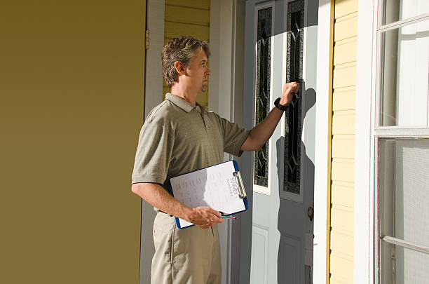 Man doing survey or petition work door-to-door Man knocking on the front door of house doing survey, political campaign or petition signing work door-to-door. census stock pictures, royalty-free photos & images