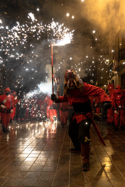 A man dressed as a devil with a sparkler in his hand during Spanish traditional festival, called Correfoc stock photo