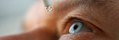 istock Man drops eye drops install lenses, moisturizing 1291273305
