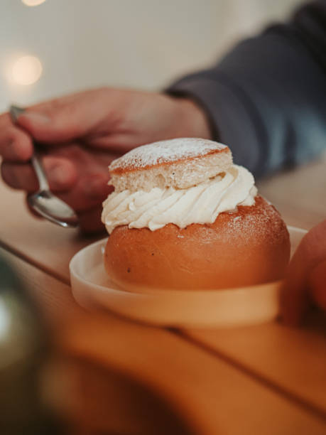Man eating typical swedish semla sweet cream bun close up stock photo