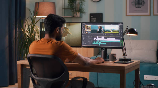 Man editing video on computer stock photo