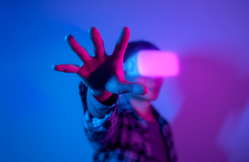 Man experiencing virtual reality eyeglasses headset,  stock photo
