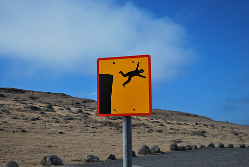 road sign of man falling off cliff. humor
