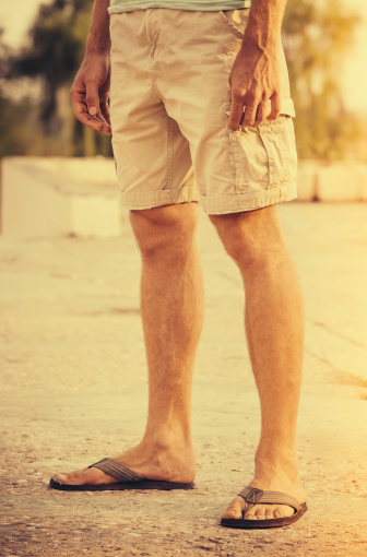 Man Feet Wearing Shorts And Flip Flops Standing Outdoor Summer Stock