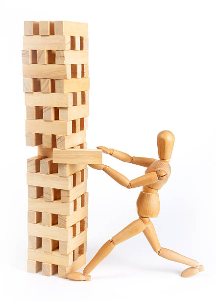 Man figure pulling or pushing wooden block Tower of wooden blocks and a man figure isolated on white background broken doll 1 stock pictures, royalty-free photos & images