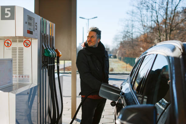 man filling a tank with fuel at the gas station in Berlin stock photo