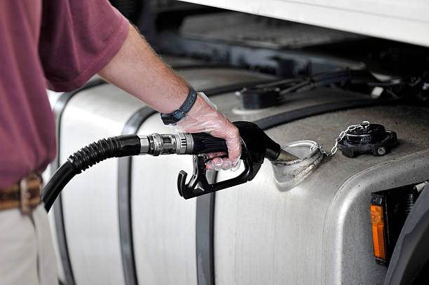 man filling up the gas tank with gasoline - tanken stockfoto's en -beelden