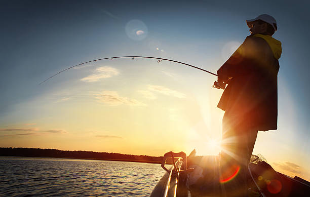 man fishing on a lake stock photo
