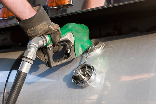 A man fuelling up a freight transport truck stock photo