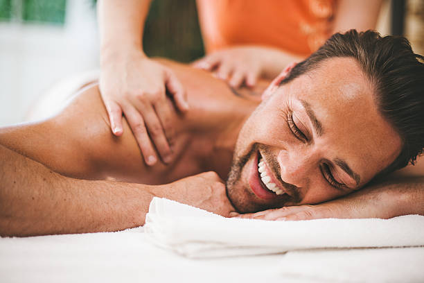 man getting a massage at the healthspa - massage stockfoto's en -beelden