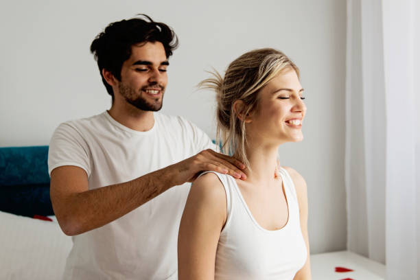 Man giving a head massage to his girlfriend stock photo