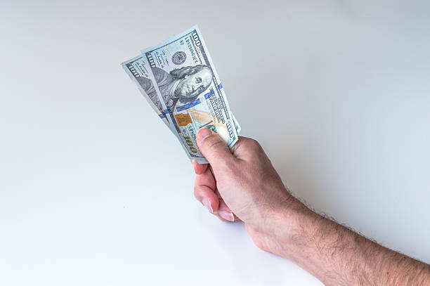 Man giving two hundred US Dollars stock photo