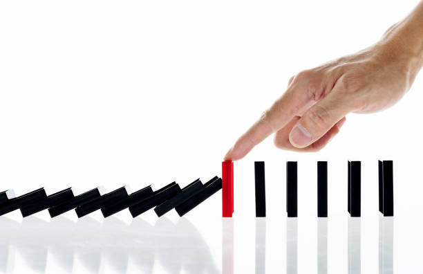 Man hand stop domino effect Man hand stop domino effect. domino stock pictures, royalty-free photos & images