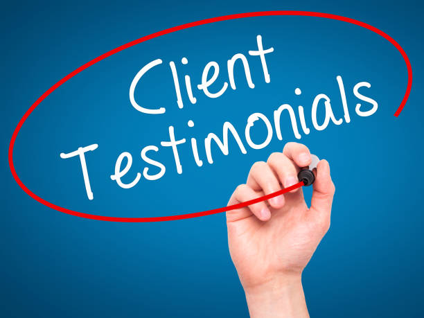 Man Hand writing Client Testimonials with black marker on visual screen stock photo