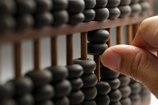 Man hands are operating abacus Old wooden abacus with a calculated abacus stock pictures, royalty-free photos & images