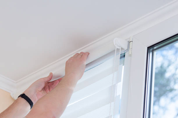Man hands installing window roller duo system day and night. Man hands installing window roller duo system day and night. roller blinds stock pictures, royalty-free photos & images