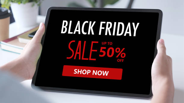 Man hands using digital tablet with black friday sale web banner on screen background, Online shopping sale, business and technology stock photo