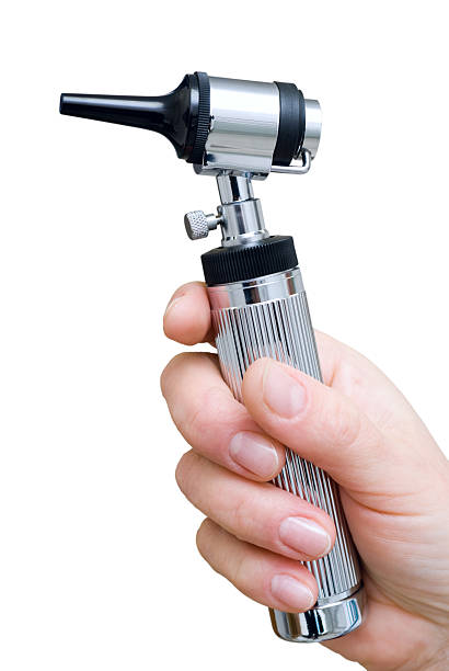 A man holding a otoscope against a white background stock photo