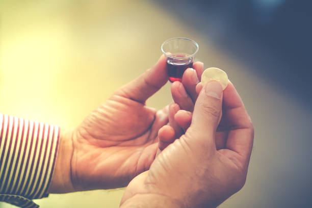 Man holding bread and wine in a Holy communion. Man holding bread and wine in a Holy communion. christian democratic union stock pictures, royalty-free photos & images
