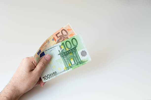 Man holding hundred and fifty Euro banknote in his hands stock photo