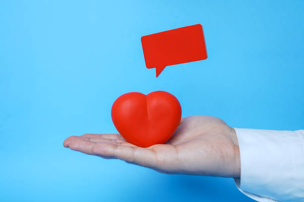 Man holding red heart and red speech bubble, health insurance, donation charity concept stock photo