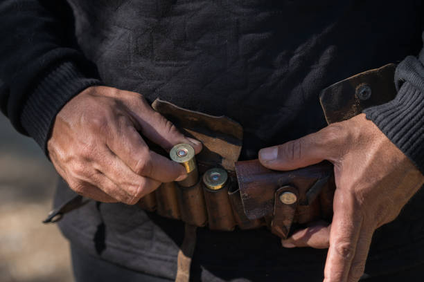 Man holding Tape with cartridges for hunting rifle Man holding Tape with cartridges for hunting rifle turkey hunting stock pictures, royalty-free photos & images