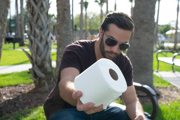 A man holding toilet paper stock photo