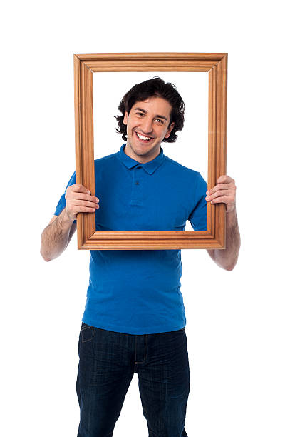 Man holding wooden picture frame stock photo