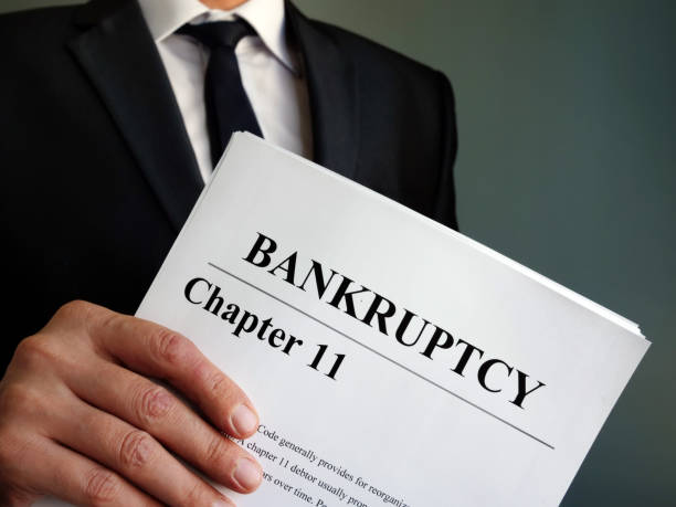 Man holds Bankruptcy Chapter 11 agreement documents. Man holds Bankruptcy Chapter 11 agreement documents. bankruptcy stock pictures, royalty-free photos & images