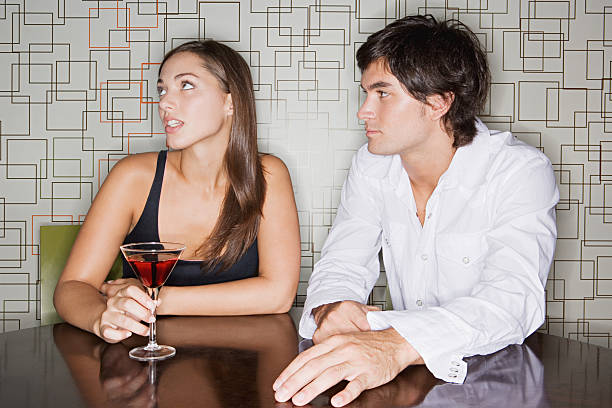 Man ignoring man in a bar  bad date stock pictures, royalty-free photos & images