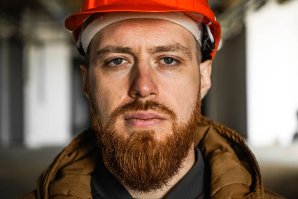 A man in a helmet looks into the frame stock photo