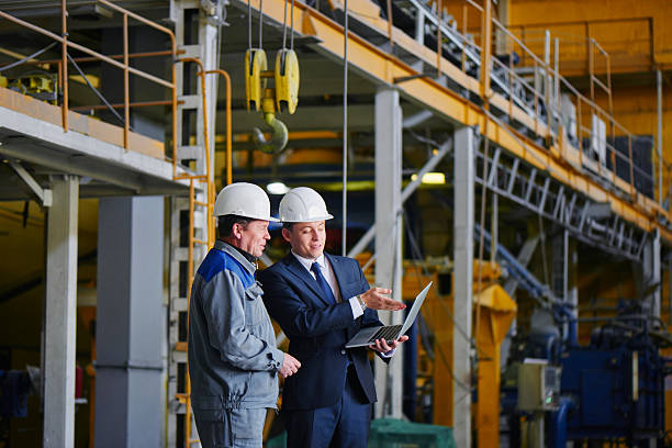 Man in a suit and a worker in overalls stock photo