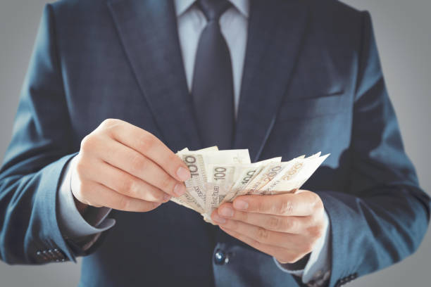 Man in a suit counts Polish banknotes stock photo