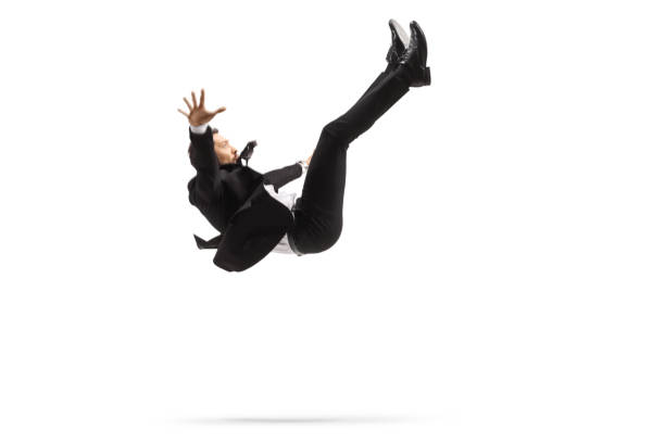 Man in a suit falling down stock photo