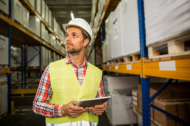 Man in a warehouse working with bar code reader stock photo