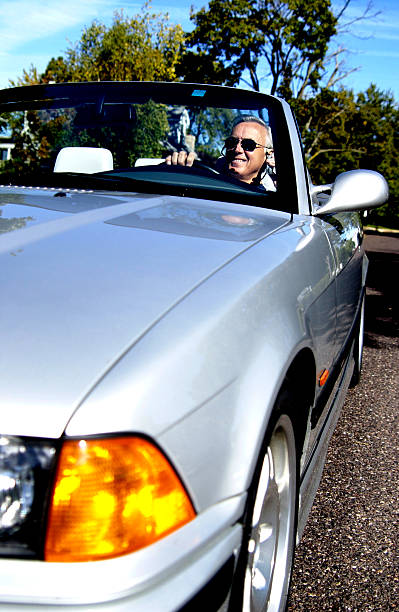 Man in convertible stock photo