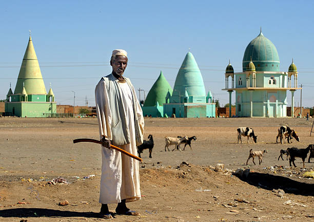 Man in front of muslim mausoleums, Sudan stock photo