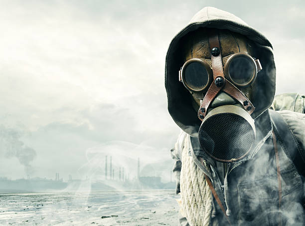 Man in gas mask witnessing environmental disaster Environmental disaster. Post apocalyptic survivor in gas mask apocalypse stock pictures, royalty-free photos & images