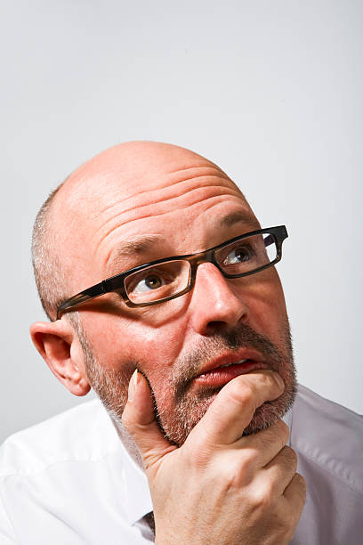 Man in glasses looking up stock photo