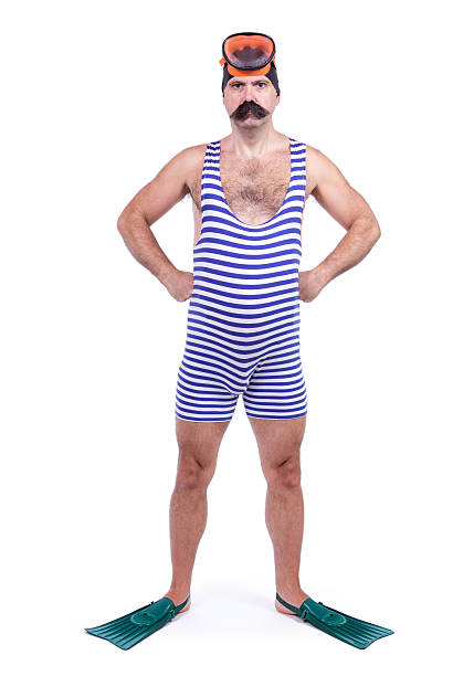 Man in swim dress standing with hands on hips stock photo