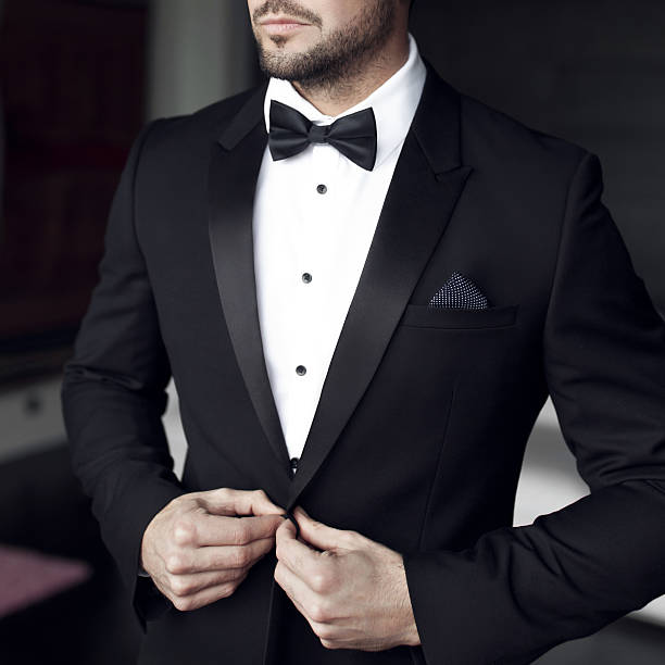man in tuxedo and bow tie - smoking stockfoto's en -beelden